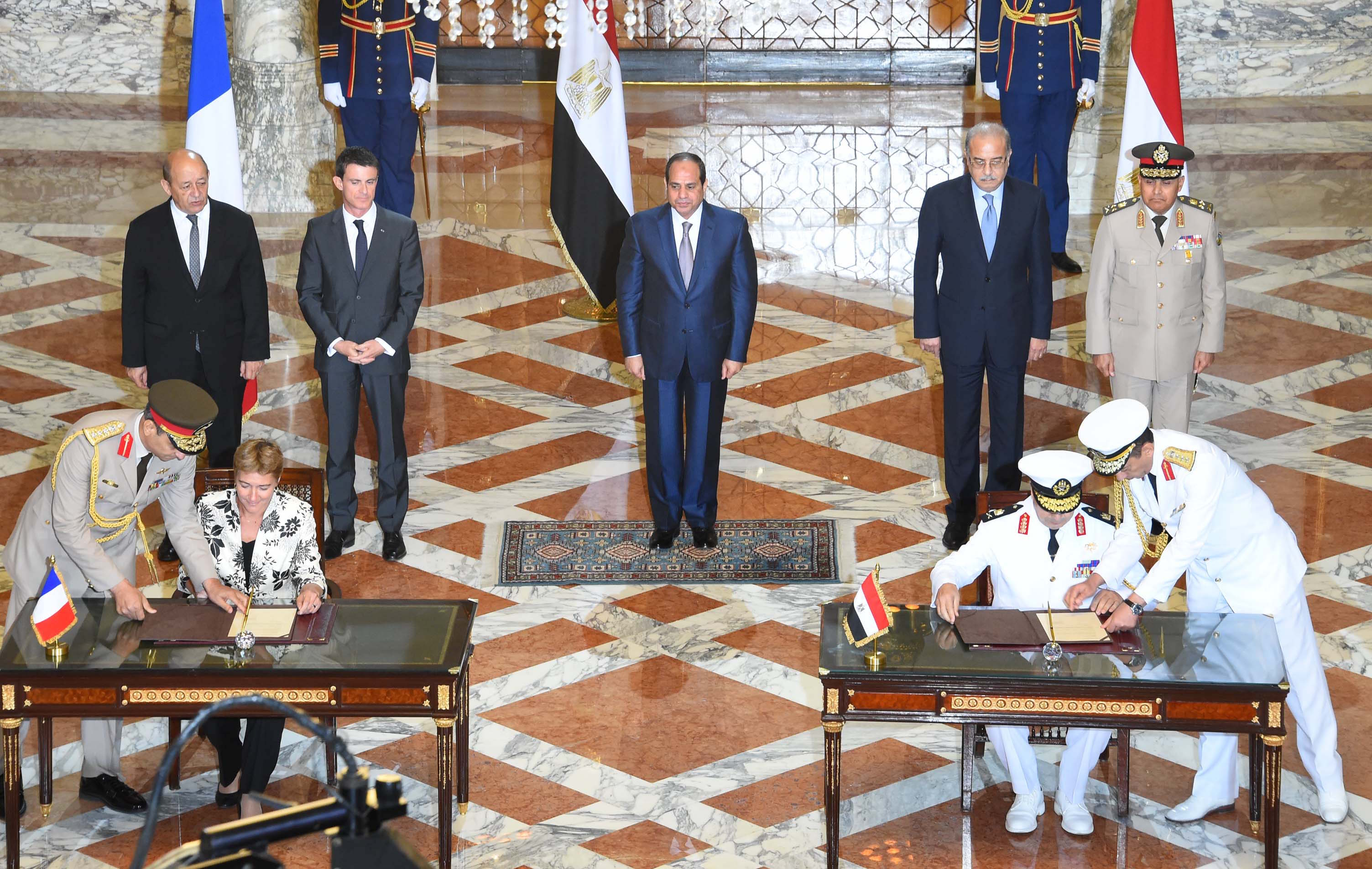 Egyptian President Abdel Fattah El-Sisi with the French and Egyptian Prime Ministers and Ministers of Defence at the deal-signing ceremony. PHOTO: Egypt's State Information Service