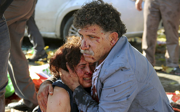 An injured man holds an injured woman after explosions targeted a peace rally in Ankara, Turkey (REUTERS/Tumay Berkin)