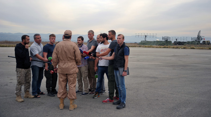 Rescued pilot of the Russian Air Force's Su-24 jet, Captain Konstantin Murakhtin, center, answers journalists' questions at Khmeimim Air Base in Latakia. Dmitriy Vinogradov/Sputnik