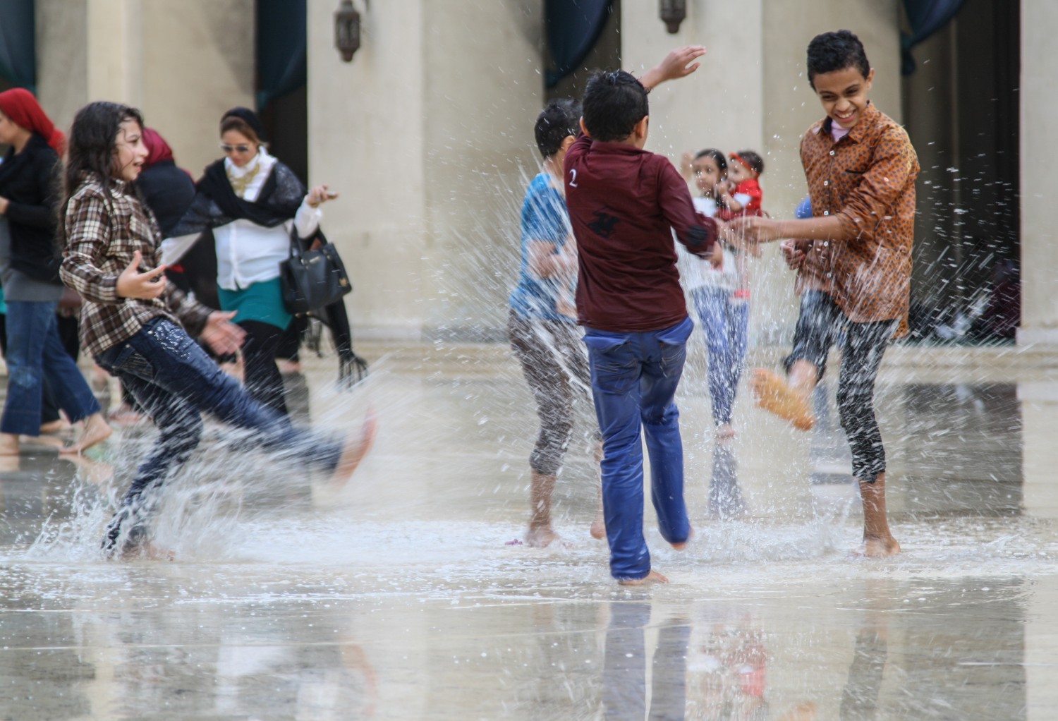 Children splashing water in the vast hall of al-Hakim mosque in Cairo after heavy rains. Credit: Enas El Masry