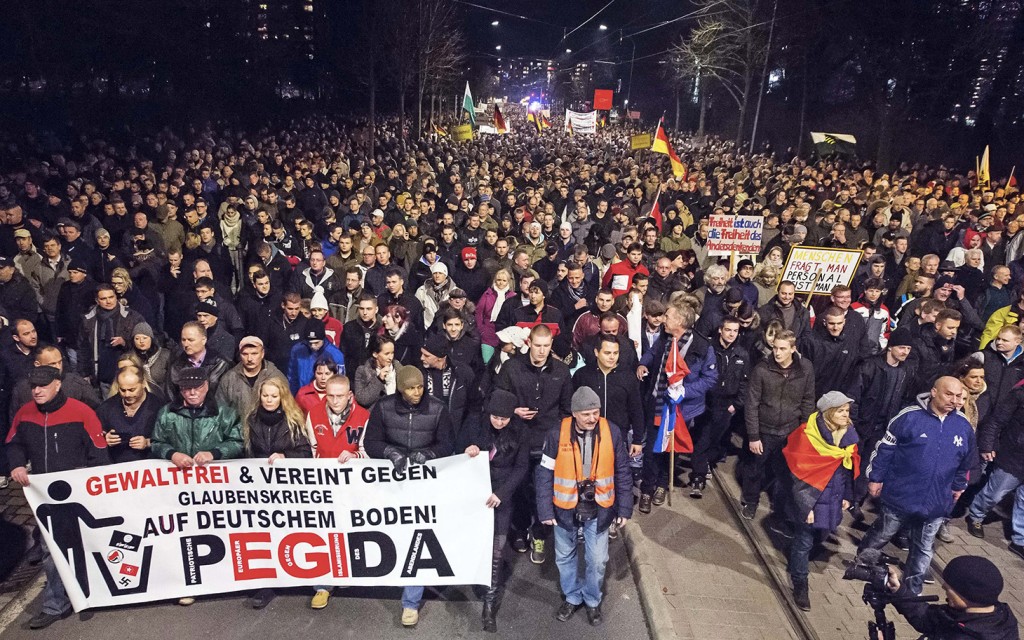 Thousands of participants of a rally called 'Patriotic Europeans against the Islamization of the West' (PEGIDA) gather in Dresden, eastern Germany, Monday, Dec. 15, 2014. (AP Photo/Jens Meyer)