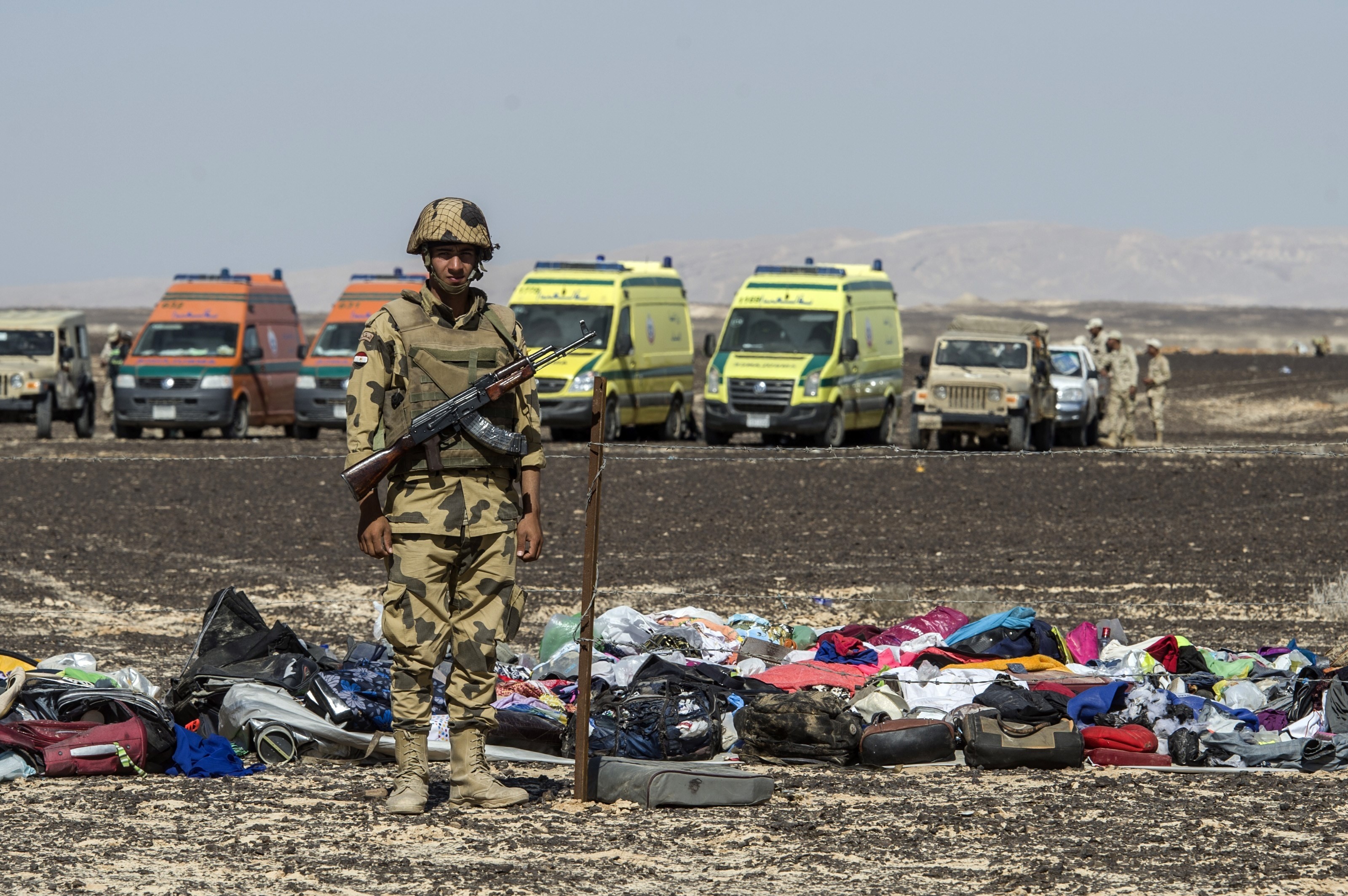 An Egyptian army soldier stands guard next to the luggage and belongings of passengers of the A321 Russian airliner piled up at the site of the crash in Wadi al-Zolomat, a mountainous area in Egypt's Sinai Peninsula on November 1, 2015.(KHALED DESOUKI/AFP/Getty Images)