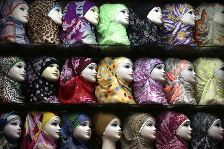 Mannequins wrapped in Islamic headscarves. Credit: Hassan Ammar/ AP