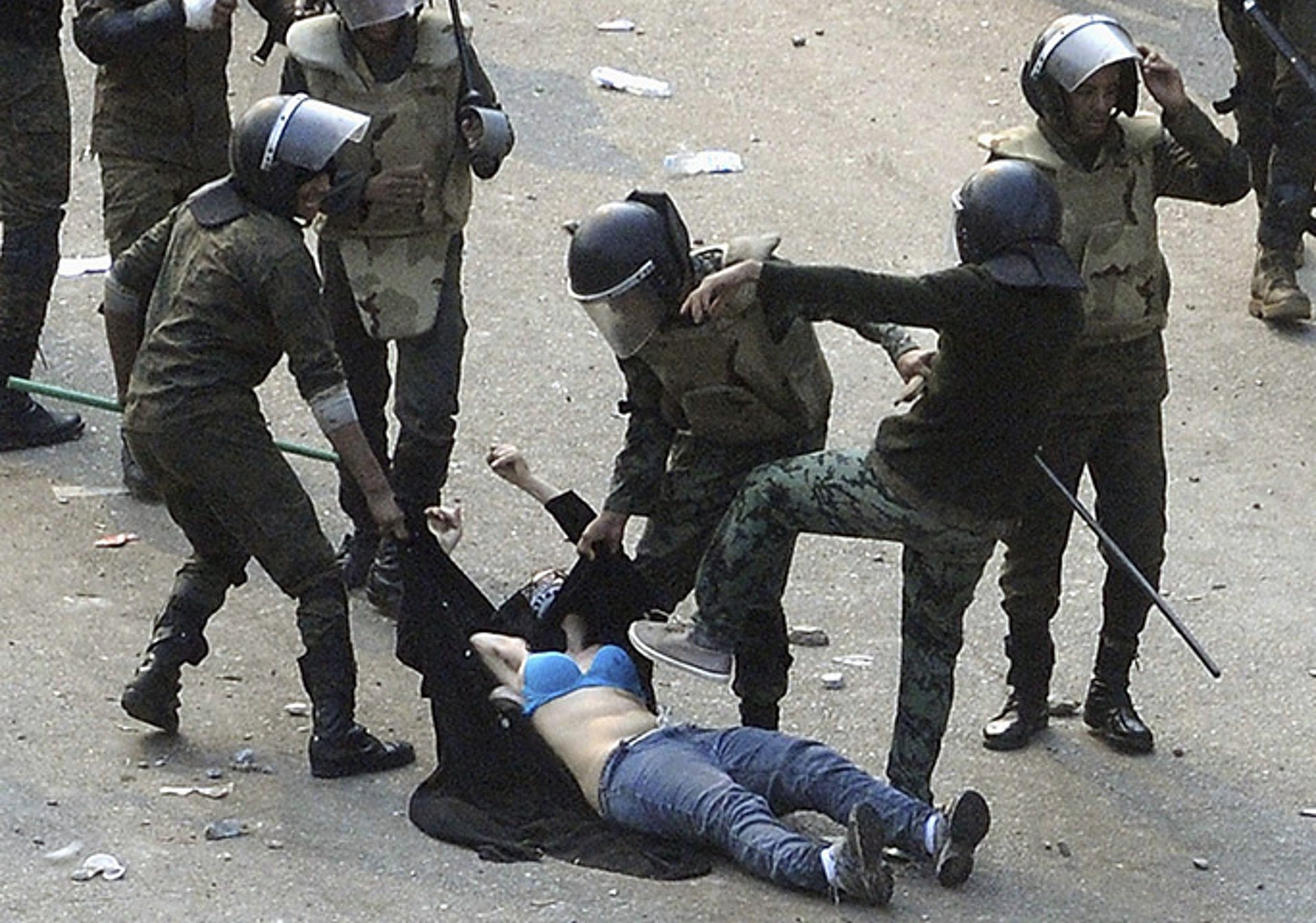 Egyptian soldiers beat a female protester during clashes at Tahrir Square, pulling up her abaya and dragging her through the street. Photo: Reuters