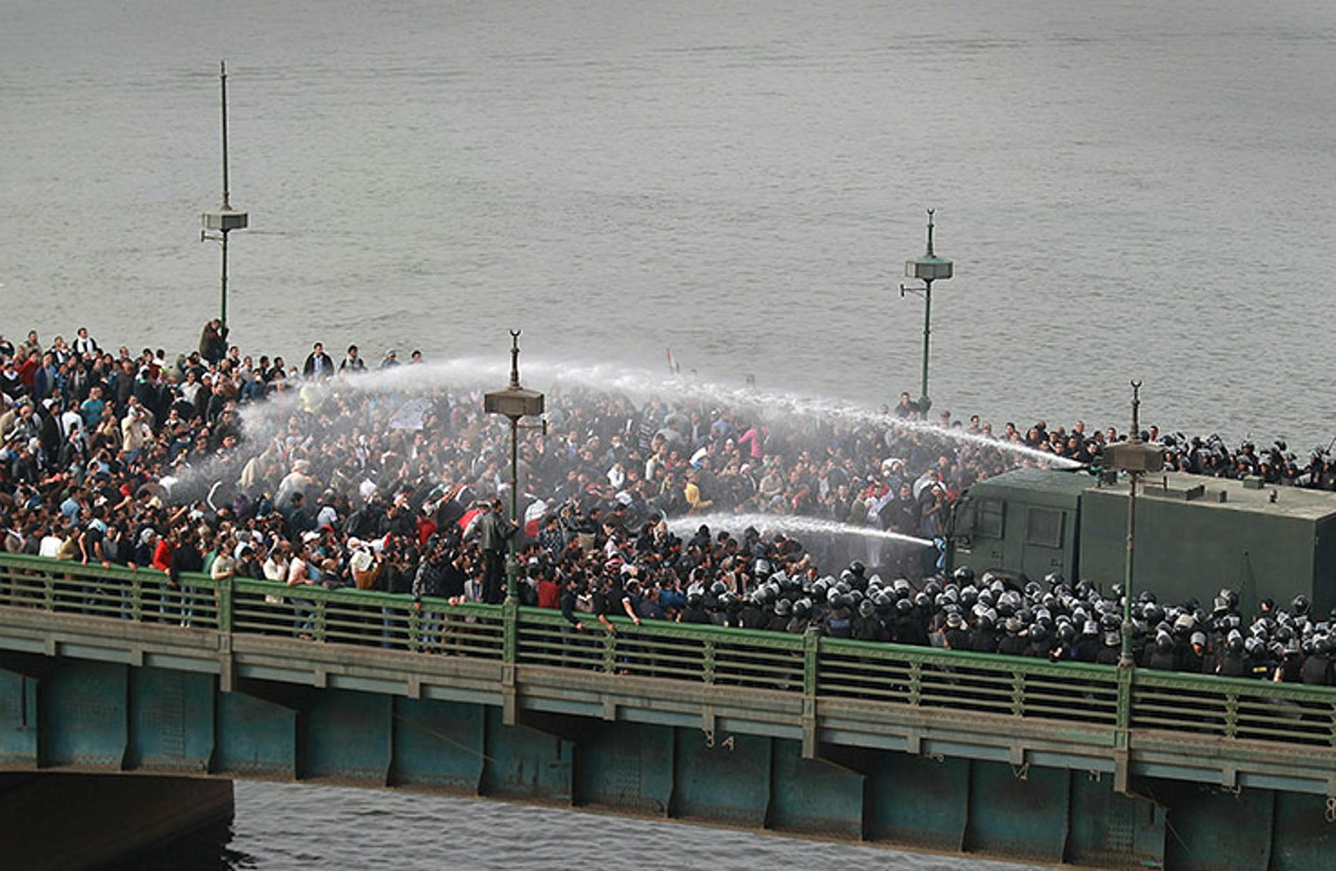 Riot police use water cannons on protesters trying to cross the Kasr al-Nile bridge. Photo: Peter Macdiarmid, Getty Images