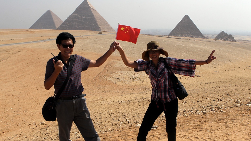 Chinese tourists posing in front of the Pyramids of Giza in Egypt. Credit Khaled Elfiqi/European Pressphoto Agency