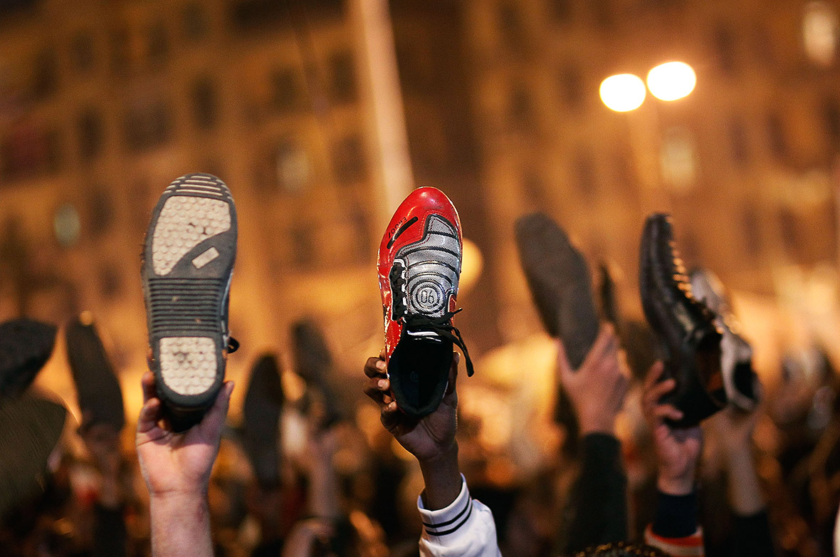 Anti-government protesters raise their shoes after a speech by Egyptian President Hosni Mubarek saying that he had given some powers to his vice president but would not resign or leave the country. Photo: Chris Hondros, Getty Images