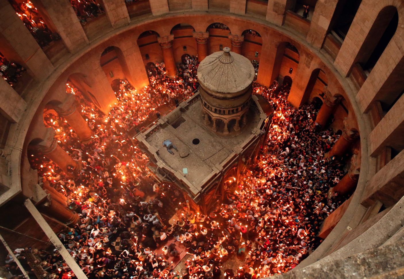 Christian Orthodox worshippers hold up candles lit from the "Holy Fire" as thousands gather in the Church of the Holy Sepulchre in Jerusalem's Old City, on April 30, 2016. Credit: Thomas Coex, AFP