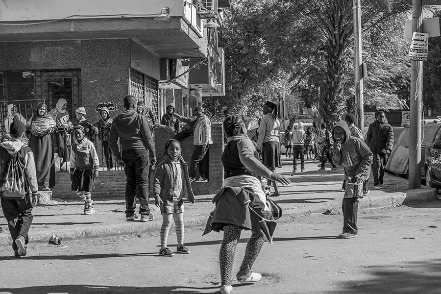Students play in the street in front of the school after school time 