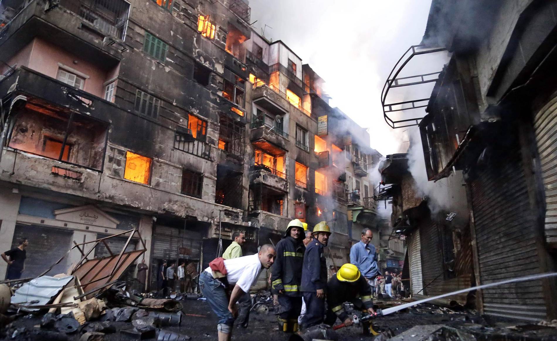 The fires continued on Monday in the buildings in Al-Rewaei while firefighters attempted it to put it off (Photo: AFP)