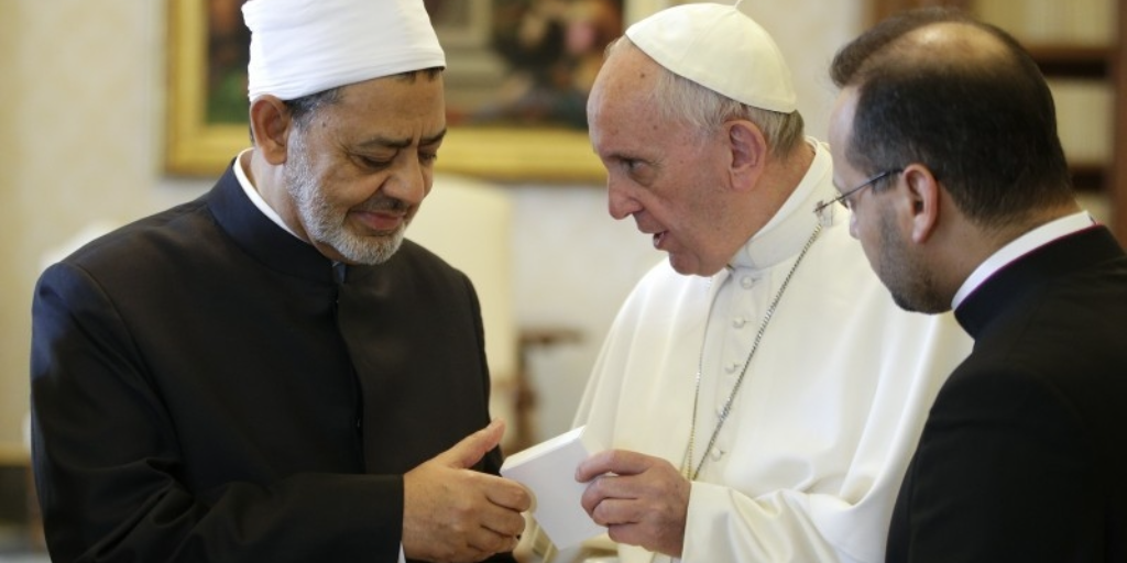 Sheik Ahmed el-Tayyib, left, Grand Imam of Al-Azhar Mosque, exchange gifts with Pope Francis during a private audience in the Apostolic Palace, at the Vatican (Max Rossi/Pool photo via AP)