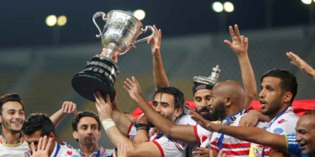 El Zamalek players celebrate with the trophy after winning their Egyptian Cup finals derby soccer match against Al Ahly. (REUTERS)