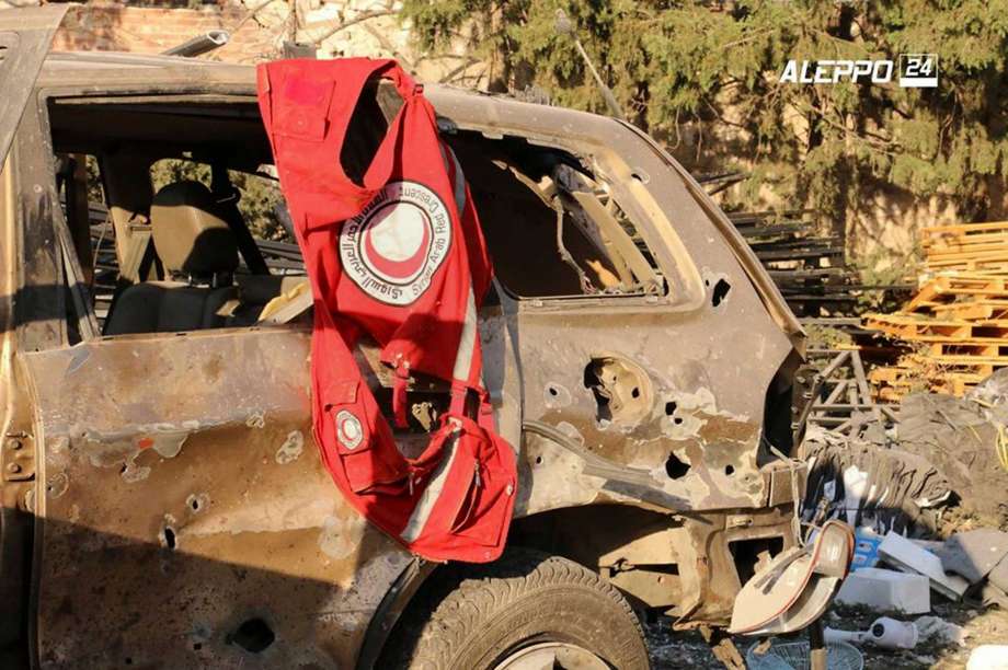 This image provided by the Syrian anti-government group Aleppo 24 news, shows a vest of the Syrian Arab Red Crescent hanging on a damaged vehicle, in Aleppo, Syria, Tuesday, Sept. 20, 2016. A U.N. humanitarian aid convoy in Syria was hit by airstrikes Monday as the Syrian military declared that a U.S.-Russian brokered cease-fire had failed, and U.N. officials reported many dead and seriously wounded. (Aleppo 24 news via AP)