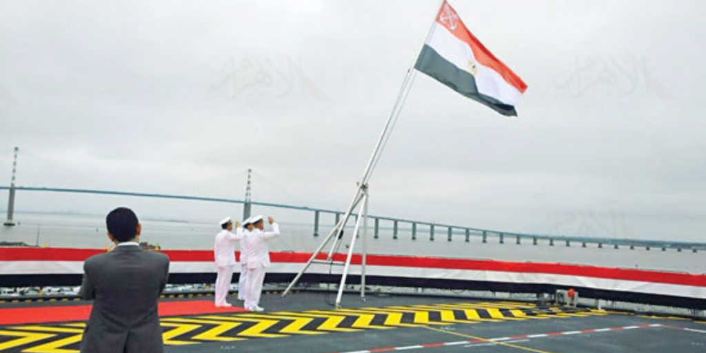 Snapshot from Egyptian TV shows Egyptian Navy officials raising the country's flag on its first-ever French Mistral helicopter carrier, named after late president Gamal Abdel Nasser, June 2, 2016