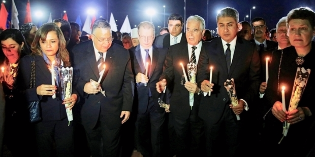 Russian Ambassador to Egypt Sergei Kerbachenko, center, marches with Egypt's government members holding candles at Peace Square during ceremony on Sunday to mark first anniversary of Russian MetroJet plane crash near Red Sea resort of Sharm el-Sheikh, Egypt (Reuters)