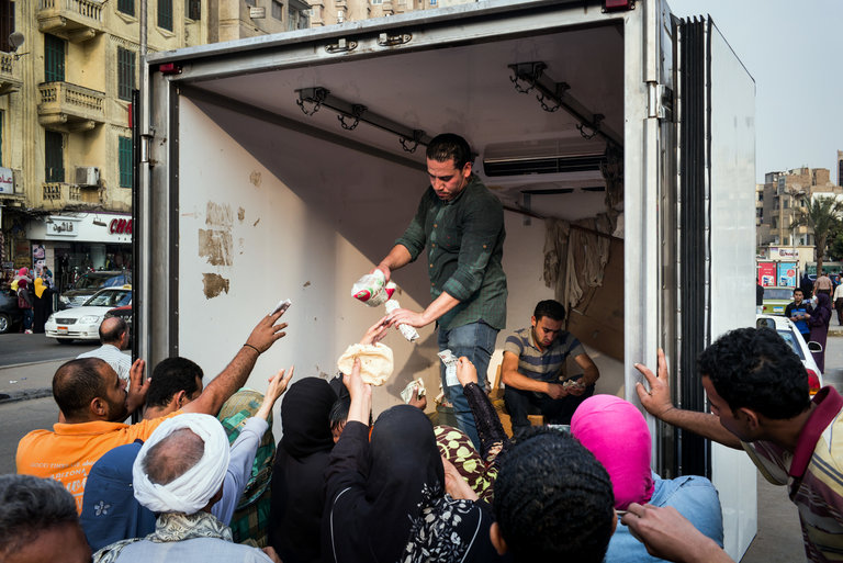 Egyptians gathered in Cairo to buy subsidized sugar from a government truck. A weeks-long sugar shortage has plunged people into a panic. (Photo: David Degner for The New York Times)