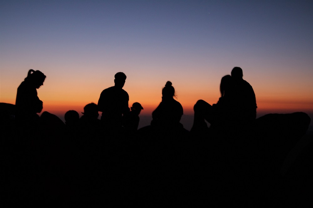 Young hikers await sunrise at the summit of Mount Sinai [Jebel Mousa]. Credit: Enas El Masry