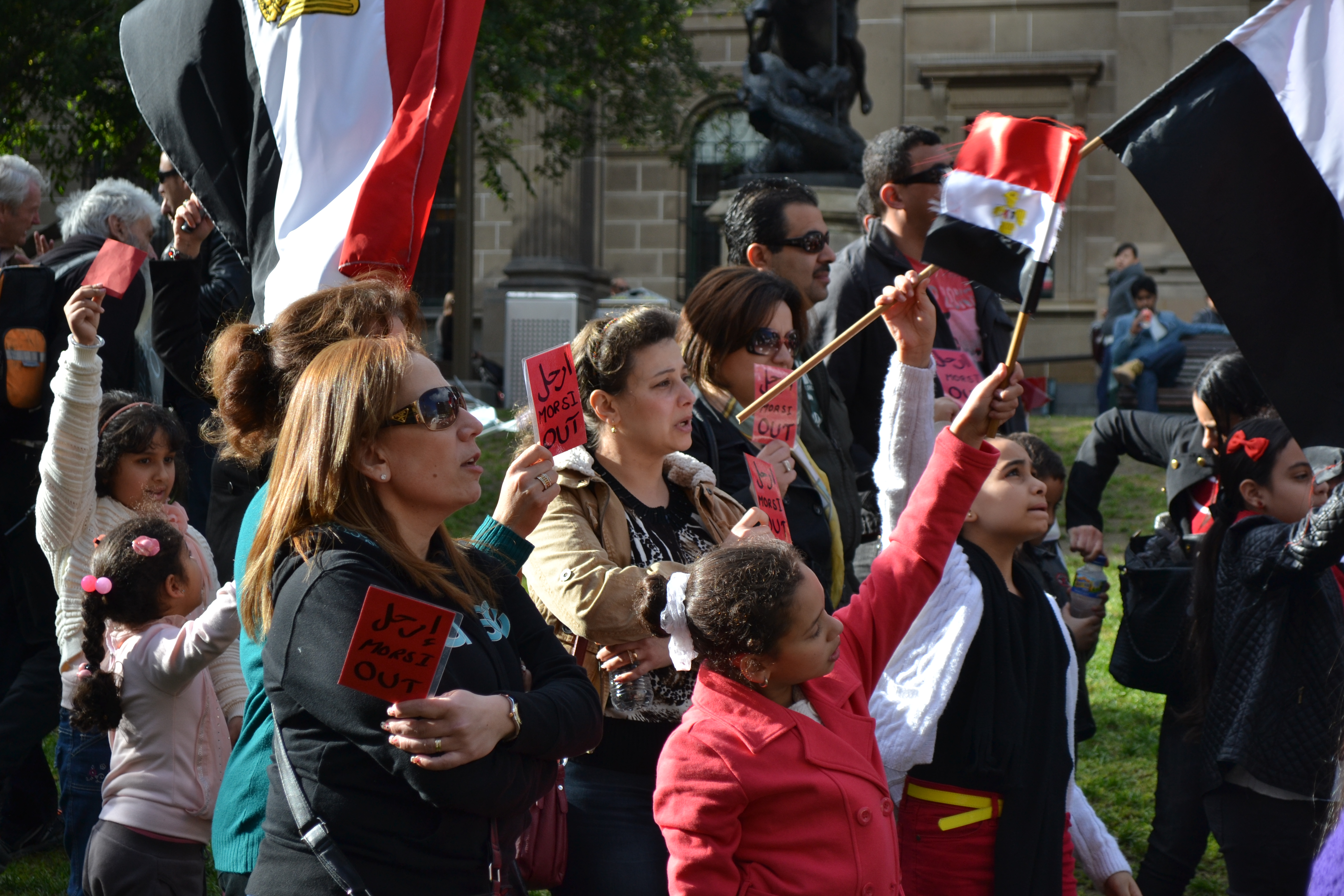 Groups of women holding 'red cards' for Morsi.