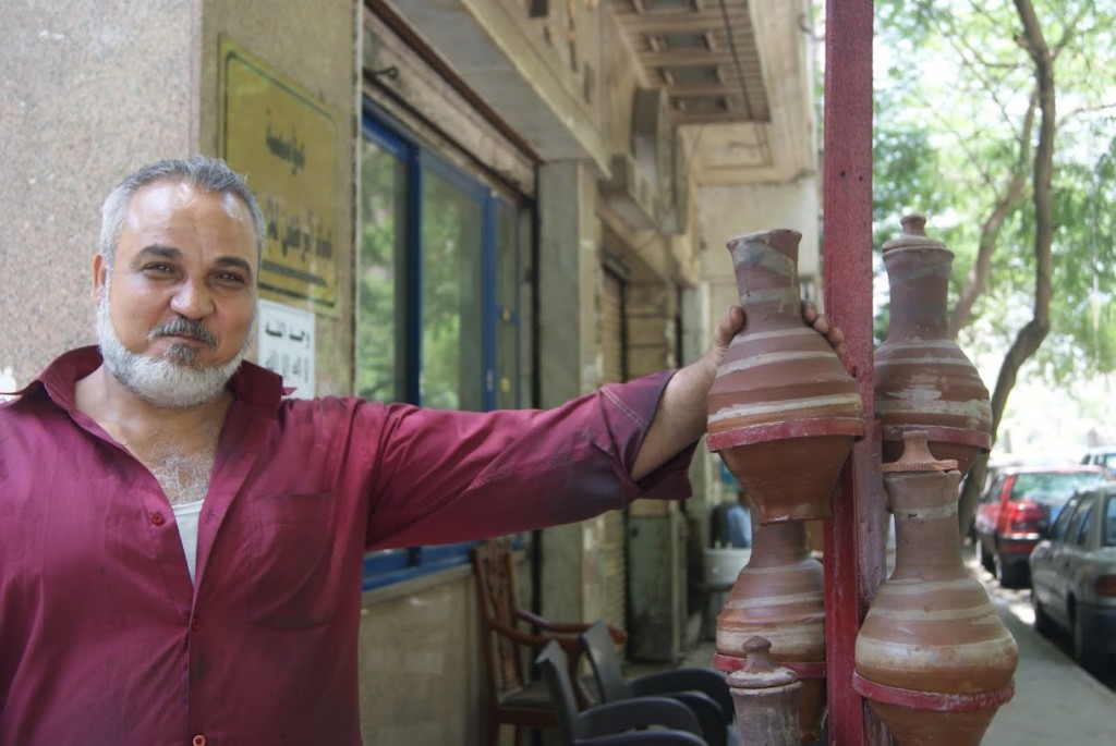 Shopkeepers put clay jars filled with water on the street for thirsty people to stop by and take a swing.