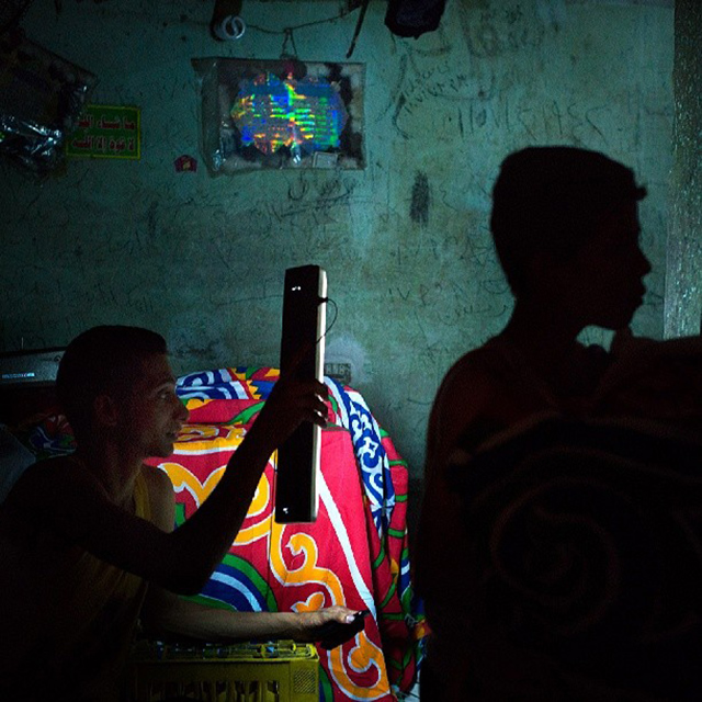 Photo by Ania Krukowska I like observing Ramadan preparations in Islamic Cairo. On many street corners, shops with fanous – traditional Ramadan lanterns – appear. People are buying decorations made of traditionally designed colorful fabric. This time I visited Tent Maker Bazaar, where many of the fabric decorations are made and sold, when suddenly a power outage occurred. Instead of leaving the dark place I took advantage of photographing their obligatory break from work in a quite unusual lightning situation.