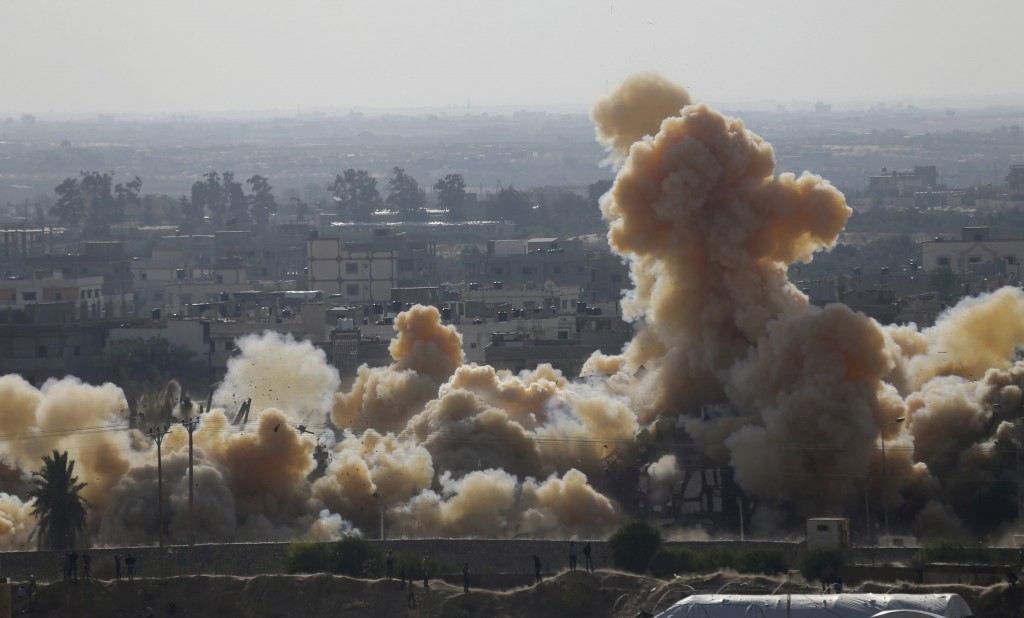 Smoke rises as a house is blown up during a military operation by Egyptian security forces in the Egyptian city of Rafah, near the border with southern Gaza Strip November 3, 2014. Egypt began clearing residents from its border with the Gaza Strip last week to create a buffer zone following some of the worst anti-state violence since President Mohamed Mursi was overthrown last year. REUTERS/Ibraheem Abu Mustafa (GAZA - Tags: POLITICS CIVIL UNREST)