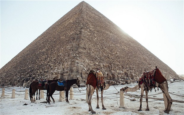 Thin snow covers the surroundings of the Giza Pyramids in Egypt after more than a century of no snow fall.