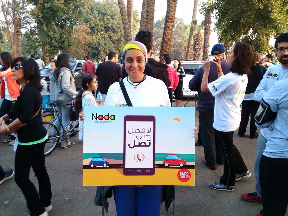 Campaign supporter holds a sign that reads: "Don't call until you arrive."