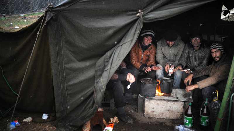 Refugees warm their hands at a refugee camp in Harmanli, Bulgaria, on Nov. 27. More Syrians are turning up in Europe. Many are trying to get to northern Europe, believing that is the best place to start a new life. Credit: Nikolay Doychinov/ AFP