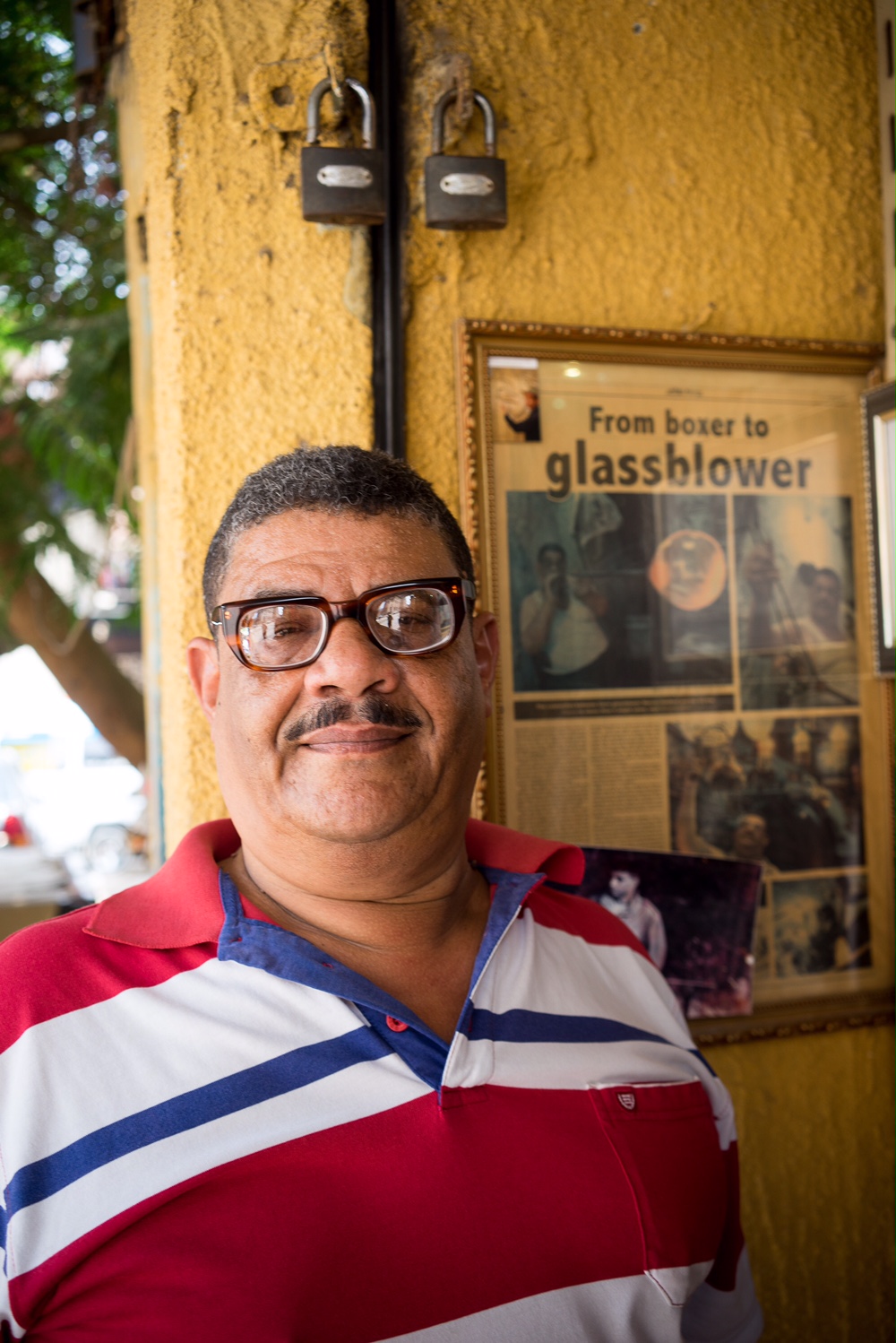 Hassan Hodhod beside one of the published articles about his story