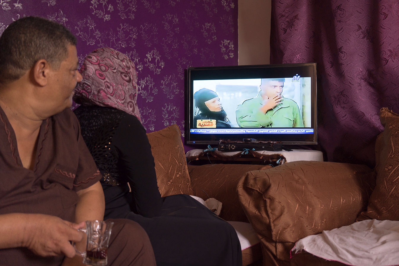 Hassan and his daughter Fayza watching the movie 'Kaboria' which depicts Hassan's early life between glassblowing and boxing. Hassan's mother played her own role in the movie alongside Ahmed Zaki.