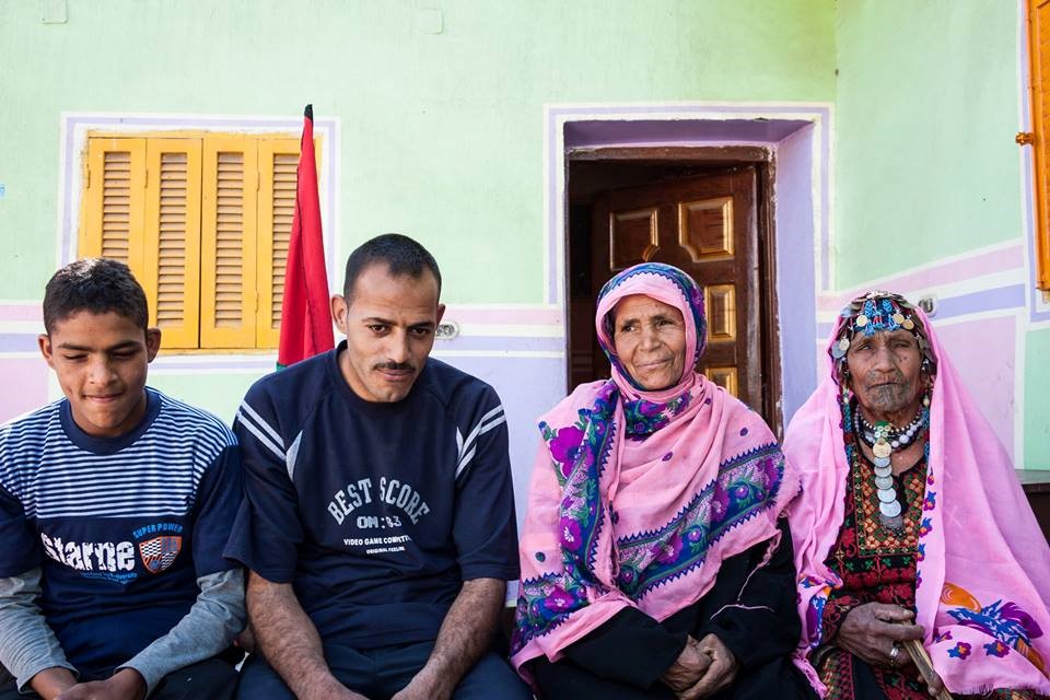 Four generations of the same family: Nafla Hassouna, aged 102, on one end of the photograph and Nedal, aged 15, on the other (Nicolas Linn)