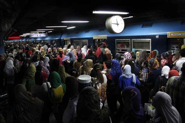 Egyptian women board a car at the Shohadaa (Martyrs) metro station in Cairo. Credit: Heba Elkholy/ AP