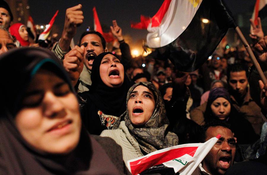 Egyptian women celebrate the news of the resignation of President Hosni Mubarak, who handed control of the country to the military, at night in Tahrir Square in downtown Cairo, Egypt Friday, February 11, 2011. Photo: Tara Todras-Whitehill, AP