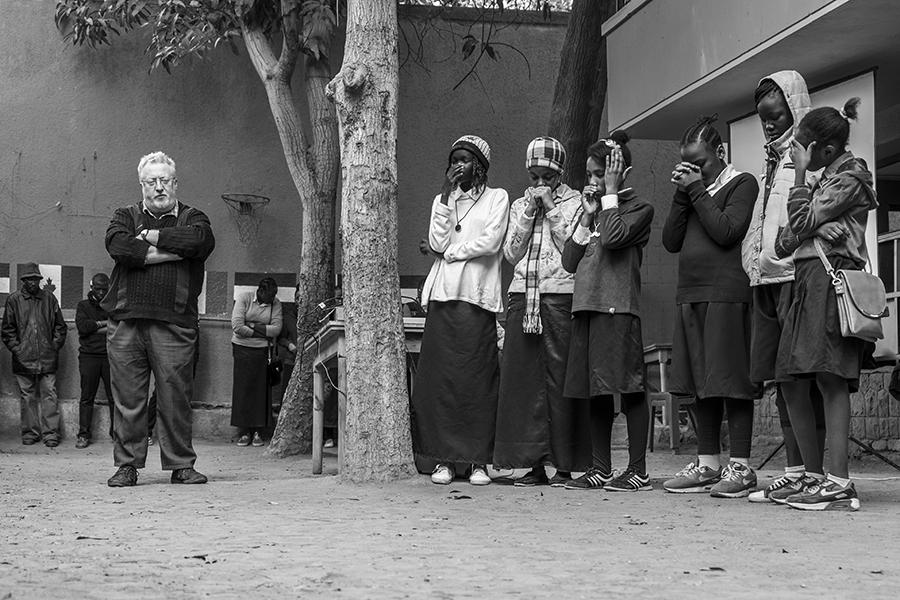 Students and teachers in the playground during morning prayers