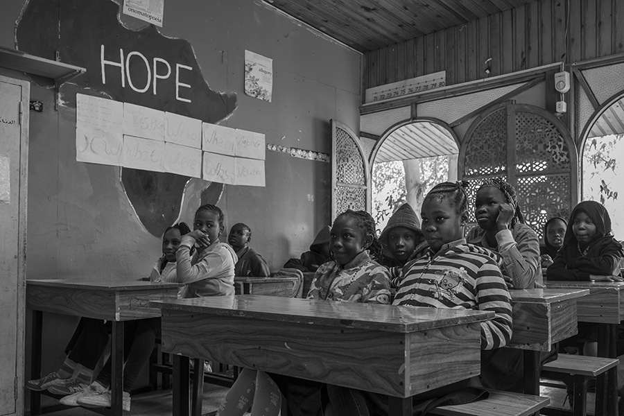 Students attentively listening to their teacher during class