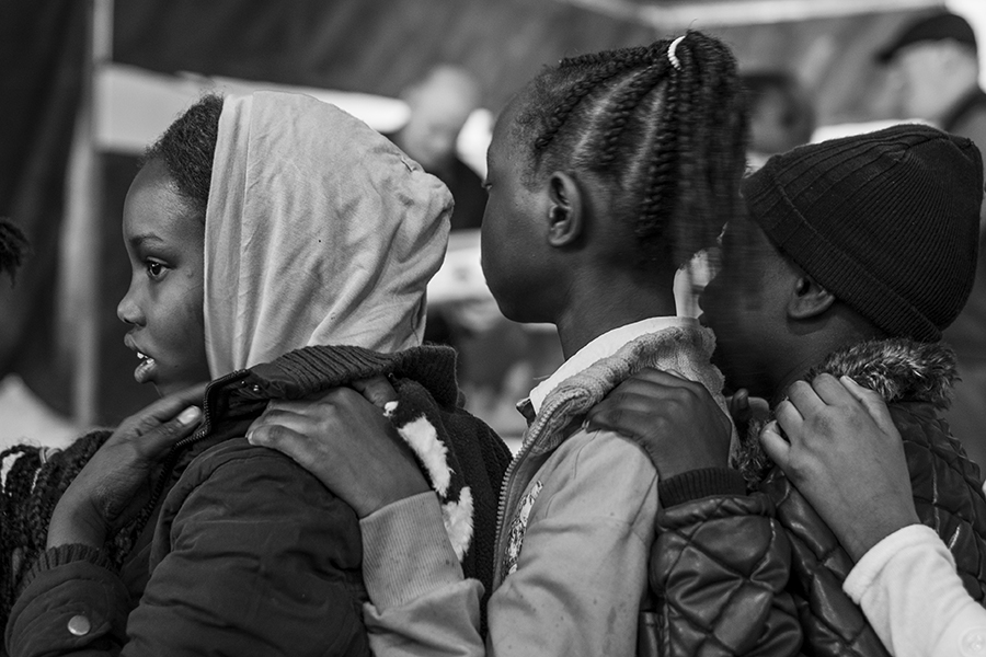 Students wait in line to receive their Christmas gifts