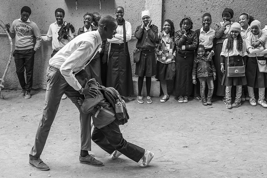 A teacher plays with one of the students in the playground