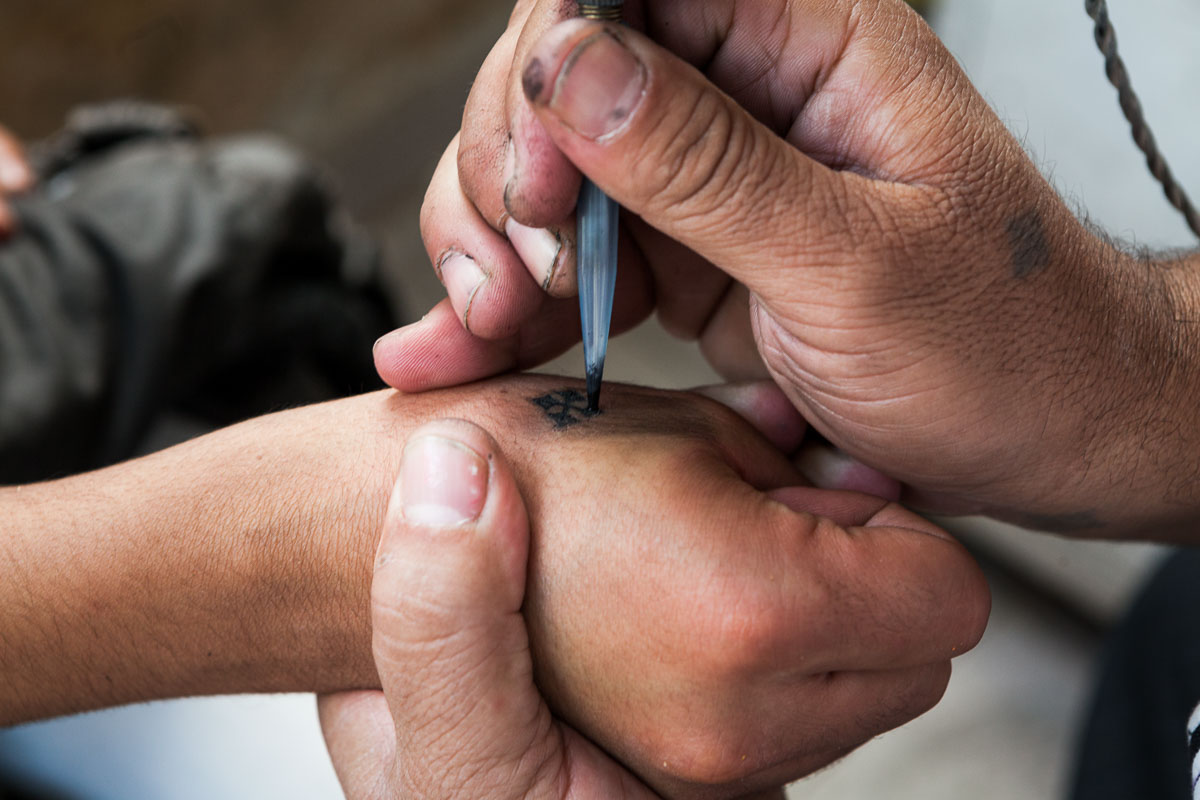 Fine line Coptic Cross tattoo on the wrist